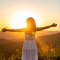 Happy woman standing with her back on sunset in nature iwith ope. Happy woman standin Royalty Free Stock Photo