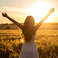 Happy woman standing with her back on sunset in nature iwith ope. Happy woman standin Royalty Free Stock Photo