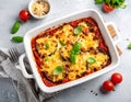 Eggplant casserole with cheese and tomato sauce in a white baking dish on a gray conc Royalty Free Stock Photo