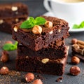 A stack of chocolate brownies with mint and hazelnuts on a dark background with cup Royalty Free Stock Photo