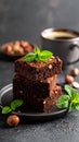 A stack of chocolate brownies with mint and hazelnuts on a dark background with cup Royalty Free Stock Photo