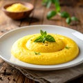 Creamy Polenta on White Ceramic Plate on Wooden Table Natural Daylight Royalty Free Stock Photo