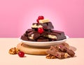 dark chocolate pieces with dried fruit, nuts and cranberries on a plate Royalty Free Stock Photo
