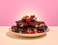 dark chocolate pieces with dried fruit, nuts and cranberries on a plate Royalty Free Stock Photo