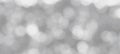 Grainy textured abstract background with bright white and gray bokeh elements
