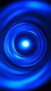 Abstract blue light swirl with bright center creating dynamic circular pattern Royalty Free Stock Photo