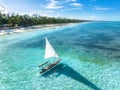 Aerial view of the sailboat on blue sea, empty white sandy beach Royalty Free Stock Photo