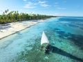 Aerial view of the sailboat on blue sea, empty white sandy beach Royalty Free Stock Photo
