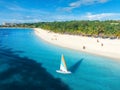 Aerial view of the sailboat on blue sea with white sandy beach Royalty Free Stock Photo