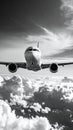 Airplane flying above dramatic clouds in black and white Royalty Free Stock Photo