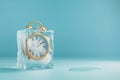 Alarm clock in ice cube, frozen time. Stopping the time concept, freeze time. Royalty Free Stock Photo