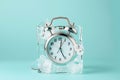 Alarm clock in ice cube, frozen time. Stopping the time concept, freeze time. Royalty Free Stock Photo
