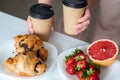Balanced breakfast with croissant, strawberries, grapefruit and coffee, concept: healthy yet enjoyable eatin Royalty Free Stock Photo