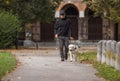 Blind woman taking a walk in a city park with her trained guide dog Royalty Free Stock Photo