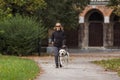 Blind woman walking in city park with a guide dog assistance Royalty Free Stock Photo