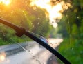 Generated image Car windshield with rain drops and frameless wiper blade closeup Royalty Free Stock Photo