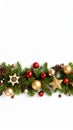 Christmas garland border with ornaments, pine cones, and stars on white background Royalty Free Stock Photo