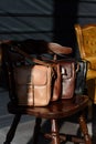close-up photo of colorful messanger leather bags on a wooden chair