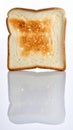 Close up of single slice of toasted bread with reflection on white surface Royalty Free Stock Photo
