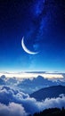 Crescent moon and starry night sky over mountain peaks and clouds Royalty Free Stock Photo