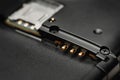 Disassembled smartphone. Macro photo of the disassembled gadget with connectors for SIM cards and battery. Selective focus Royalty Free Stock Photo