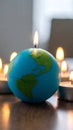 Earth Globe Candle Burning Surrounded by Tealights for Global Awareness Royalty Free Stock Photo