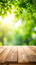 Empty wooden table in foreground with lush green leaves and sunlight bokeh background Royalty Free Stock Photo