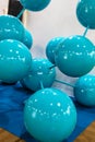 An exhibition of blue balls arranged in the shape of a crystal.