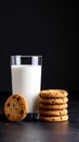 Glass of milk and stack of chocolate chip cookies on a dark surface Royalty Free Stock Photo