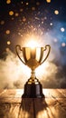 Golden trophy sparkles with light and bokeh effects on wooden surface Royalty Free Stock Photo