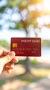 Hand holding red credit card with chip outdoors Royalty Free Stock Photo