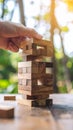 Hand Placing Block on Wooden Tower Game Outdoors Royalty Free Stock Photo