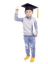 Happy Asian school kid graduate in graduation cap and hand pointing up Royalty Free Stock Photo