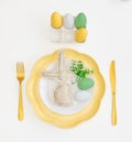 Happy Easter. Easter celebration concept. Top view vertical empty white, yellow plate, decorative rabbit, eggs, Royalty Free Stock Photo
