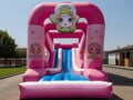 Inflatable colorful Princess bounce house water slide in the backyard. Playground for children.