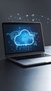 Laptop displaying cloud computing and world map graphic on dark background Royalty Free Stock Photo