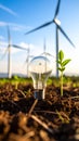 Lightbulb with seedling and wind turbines representing renewable energy and nature Royalty Free Stock Photo