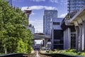 Low rail view of train tracks entering downtown along elevated transit platform Royalty Free Stock Photo