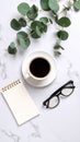 Minimalist flat lay with coffee cup eucalyptus branch blank notebook and reading glasses on white marble Royalty Free Stock Photo