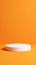 Minimalist white cylinder podium on a vibrant orange background for product display Royalty Free Stock Photo