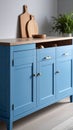 Modern blue sideboard with wooden countertop and cutting boards in a bright kitchen setting Royalty Free Stock Photo