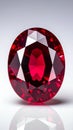 Oval-cut ruby gemstone with vibrant red color and facets reflecting light on white background Royalty Free Stock Photo