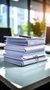 Pile of documents and pen on a desk in a bright office setting Royalty Free Stock Photo