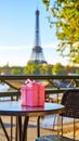 Pink gift box on a table overlooking the Eiffel Tower in Paris on a sunny day Royalty Free Stock Photo