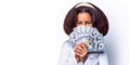 Portrait of a happy young african woman holding bunch of money banknotes isolated over white background. Portrait smile