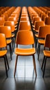 Rows of vibrant orange chairs in an empty modern conference room or auditorium Royalty Free Stock Photo