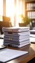 Stack of documents on a desk in a bright office with sunlight Royalty Free Stock Photo