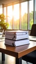 Stack of Documents on Office Desk with Laptop and Sunlight Royalty Free Stock Photo