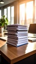 Stack of Documents on Office Desk with Sunlight and Laptop Royalty Free Stock Photo