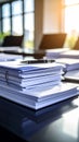 Stack of documents with pen on a desk in a bright office setting Royalty Free Stock Photo